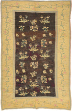 bunches of grapes, leaves and various floral forms on an open brown/black ground.  blossoming vines that meander around the perimeter on a canary yellow ground. It is woven in a curvilinear style that utilizes so-called "eccentric wefts" associated with weaving from Kiev and the regions further east. Hali magazine has published Ukrainian Decorative Folk Art Museum. The combination of eccentric wefts, coloration and the subject of grapes help attribute this example to Kiev or nearby Chernihiv. palimpsest