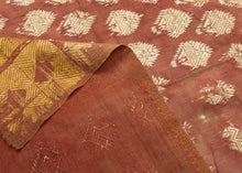 19th century Phulkari is a tradition of folk embroidery from the Punjab region that encompasses both India and Pakistan. This Phulkari was crafted in four strips and composed  of ivory and gold silken thread atop terracotta dyed cotton.