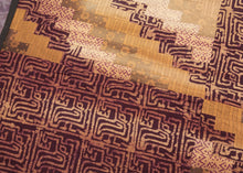 This batik patchwork was crafted in Indonesia during the 20th century.
Batik is a wax-resist technique that creates a distinctive style. This textile features a variety of batik designs that have been patchworked together into four quadrants creating a dynamic design in purples and yellows. 