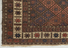 afghan baluch lattice design composed of field of soft red and purple diamonds.  Framed by a vibrant white main border of eight pointed stars that really brightens the piece.