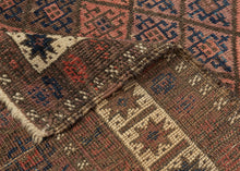 afghan baluch lattice design composed of field of soft red and purple diamonds.  Framed by a vibrant white main border of eight pointed stars that really brightens the piece.