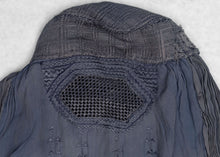 This Burqa was crafted in Afghanistan during the late 20th century. 
A burqa is a full-body garment that covers a woman's face and body. This burqa is made of periwinkle blue fabric with crimping around the back and floral embroidery below mesh opening for the eyes.
It is in good condition with small patches and some sun fading.
Special Provenance: Formerly in the collection of Yosi Barzilai Sarajo