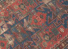 This Shirvan rug was woven in the Caucasus during the late 19th century.
It features three powerful leshgi stars on an earthy red ground full of various rosettes and protection symbols.  Encapsulated by multiple individualized borders including rosettes, sunbursts, and calyx and serrated leaves. A very handsome palette of blues, reds, greens and aubergine is accentuated by glowing coral and orange among other tones.