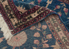 This Mohajeran Sarouk was handwoven during the first quarter of the 20th century. 
It features an imaginative tree of life design of a small cypress flanked by two whimsically intersecting trees bearing palmette-shaped "fruit" on an inky blue ground. . Plush and well-executed these best-of-type Sarouks are referred to as "Mohajeran". Thinly framed like a painting with a generously spaced floral main border flanked by minor borders of polychrome circles;This classically patterned rug should