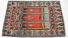 This Senneh rug was woven during the second quarter of the 20th Century.
Wonderful but still folky perspective of looking into a building with three arches each with a hanging lantern. The perspective is accentuated by a grid which runs into a columned platform before breaking off into the glowing red distance. The piece is further differentiated by the addition of a zoomorphic alter directly in the center.