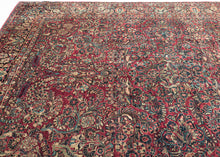 This rug features a curvilinear floral design on a red wine field. The floral work is intricate and an excellent example of the type of floral sprays Sarouk rugs are famed for. The main border features a palmette and blossom design on a navy ground. This classically patterned rug is perfect for high traffic areas and should last for generations to come. 