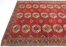 This Tekke main rug was handwoven during the first quarter of the 20th century in Turkmenistan.
The field features a grid rounded main guls in apricot, indigo, turquoise and ivory on vibrant red ground. The space between the grid i
The field features a grid rounded main guls in apricot, indigo, turqoise and ivory on vibrant red ground. The space between the grid is filled with rows of cruciform shaped secondary guls. In a rare square format that allows for very luxurious and open spacing of the guls.