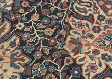 This rare and expressive Kurdish wagireh—or sampler rug—is a visual archive of design. Woven not for the market but as a reference tool, wagireh offered master weavers a compact way to preserve and transmit important elements of a pattern. Lush florals, scrolling vinery, and medallion fragments bloom in bold juxtaposition, floating across an asymmetrical field divided by tone and structure. The field’s deep indigo ground plays host to densely branched flowerheads and palmettes, while a large-scale ivory car