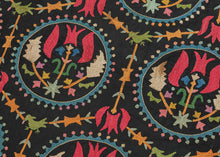 This embroidered textile is a well-preserved example of late Ottoman Armenian domestic needlework, likely produced in the town of Marash (modern-day Kahramanmaraş, Turkey) at the turn of the 20th century.  
The embroidery is executed in silk floss using satin and couching stitches across a black cotton ground.  It features concentric floral medallions, stylized birds and serrated leaves in lively blues, greens, red, pink, purple, yellow and ivory. Notably, two guardian-like anthropomorphic figure