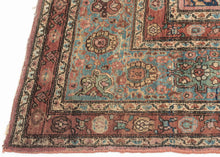 This piece showcases a graceful allover floral design anchored by a central medallion in soft rose and muted green tones. The generous borders, framed in sky blue and rust, add depth and contrast while highlighting the sophisticated floral latticework in the field. Finely woven with a dense, durable pile, this rug embodies the exceptional craftsmanship for which Sarouks are renowned
