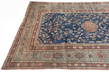 This piece showcases a graceful allover floral design anchored by a central medallion in soft rose and muted green tones. The generous borders, framed in sky blue and rust, add depth and contrast while highlighting the sophisticated floral latticework in the field. Finely woven with a dense, durable pile, this rug embodies the exceptional craftsmanship for which Sarouks are renowned