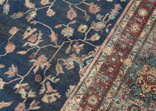 This piece showcases a graceful allover floral design anchored by a central medallion in soft rose and muted green tones. The generous borders, framed in sky blue and rust, add depth and contrast while highlighting the sophisticated floral latticework in the field. Finely woven with a dense, durable pile, this rug embodies the exceptional craftsmanship for which Sarouks are renowned