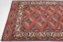 This Yomud Turkmen rug was handwoven during the early 20th century in Western Turkmenistan.
This finely balanced Yomud carpet features a repeating dyrnak-gul field in shades of plum, indigo, ivory, coral, apricot and sky blue. Each diamond-shaped motif radiates a strong tribal geometry, emblematic of Yomud weavings from the Caspian steppe.
