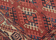 This Yomud Turkmen rug was handwoven during the early 20th century in Western Turkmenistan.
This finely balanced Yomud carpet features a repeating dyrnak-gul field in shades of plum, indigo, ivory, coral, apricot and sky blue. Each diamond-shaped motif radiates a strong tribal geometry, emblematic of Yomud weavings from the Caspian steppe.
