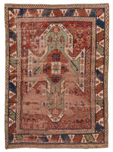 This rug features famous "shield" design associated with the very collectible Sewan Kazaks.&nbsp; It is rendered with strong shield-like medallion in soft jade on a patinated red field. The rest of the palette included lively blues, calm yellows, ivory and oxidized brown.&nbsp; Framed by a strong border of stepped triangles alternating with curled tendrils. All in a rare and desirable room size!