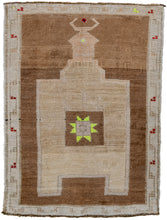 It features a directional camel ground mihrab atop an open chocolate ground. The center of the mihrab features a square in the same chocolate ground filled with an eight pointed star. The star sparkles in a very prominent highlighter yellow. Framed by a simple scrolling cream border with groupings of small red berries and a couple pops of yellow. KARS