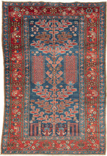 This unusual Karaja rug features a Tree of Life composition rendered in a vivid palette of indigo, madder, ivory, and soft terracotta tones. It combines the technical precision and geometric boldness typical of Karaja weavings with a spiritually resonant format more commonly associated with urban workshop rugs.