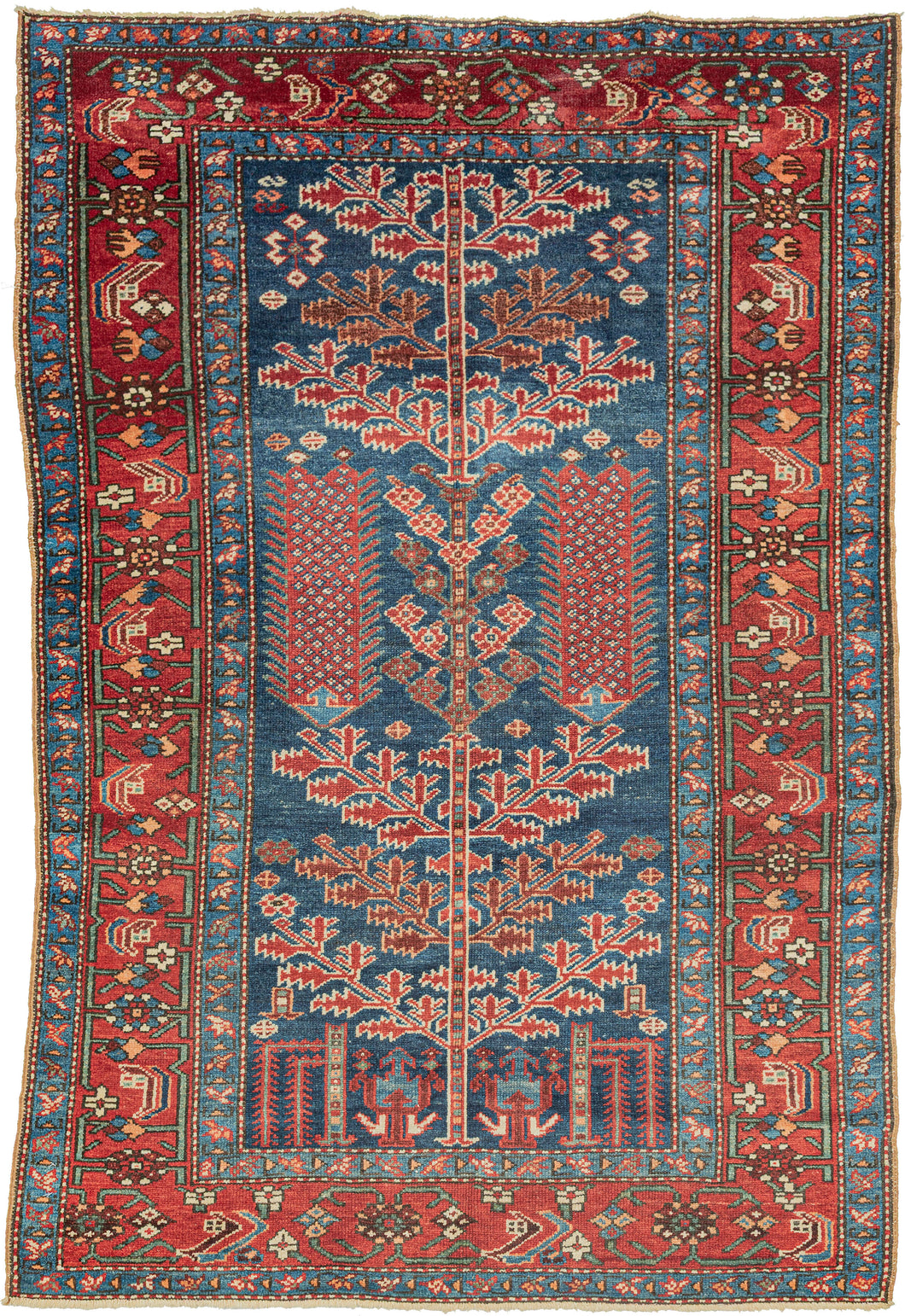 This unusual Karaja rug features a Tree of Life composition rendered in a vivid palette of indigo, madder, ivory, and soft terracotta tones. It combines the technical precision and geometric boldness typical of Karaja weavings with a spiritually resonant format more commonly associated with urban workshop rugs.