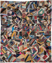 Crazy-quilting reached its peak in the late 1800s.  This particular quilt was composed during the height of this movement and epitomizes the Victorian design sense. It features many symbols, a variety of fabrics and tiny detailed embroidered "borders" around each swatch of fabric. The symbols include fans, flowers and remarkably even an embroidered face.This piece was intended as and actually used as a family heirloom