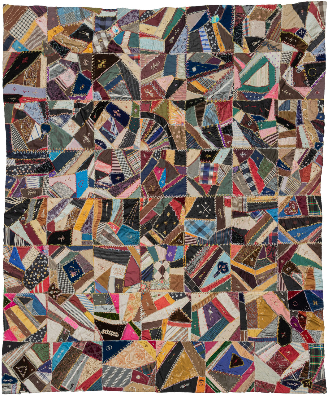 Crazy-quilting reached its peak in the late 1800s.  This particular quilt was composed during the height of this movement and epitomizes the Victorian design sense. It features many symbols, a variety of fabrics and tiny detailed embroidered