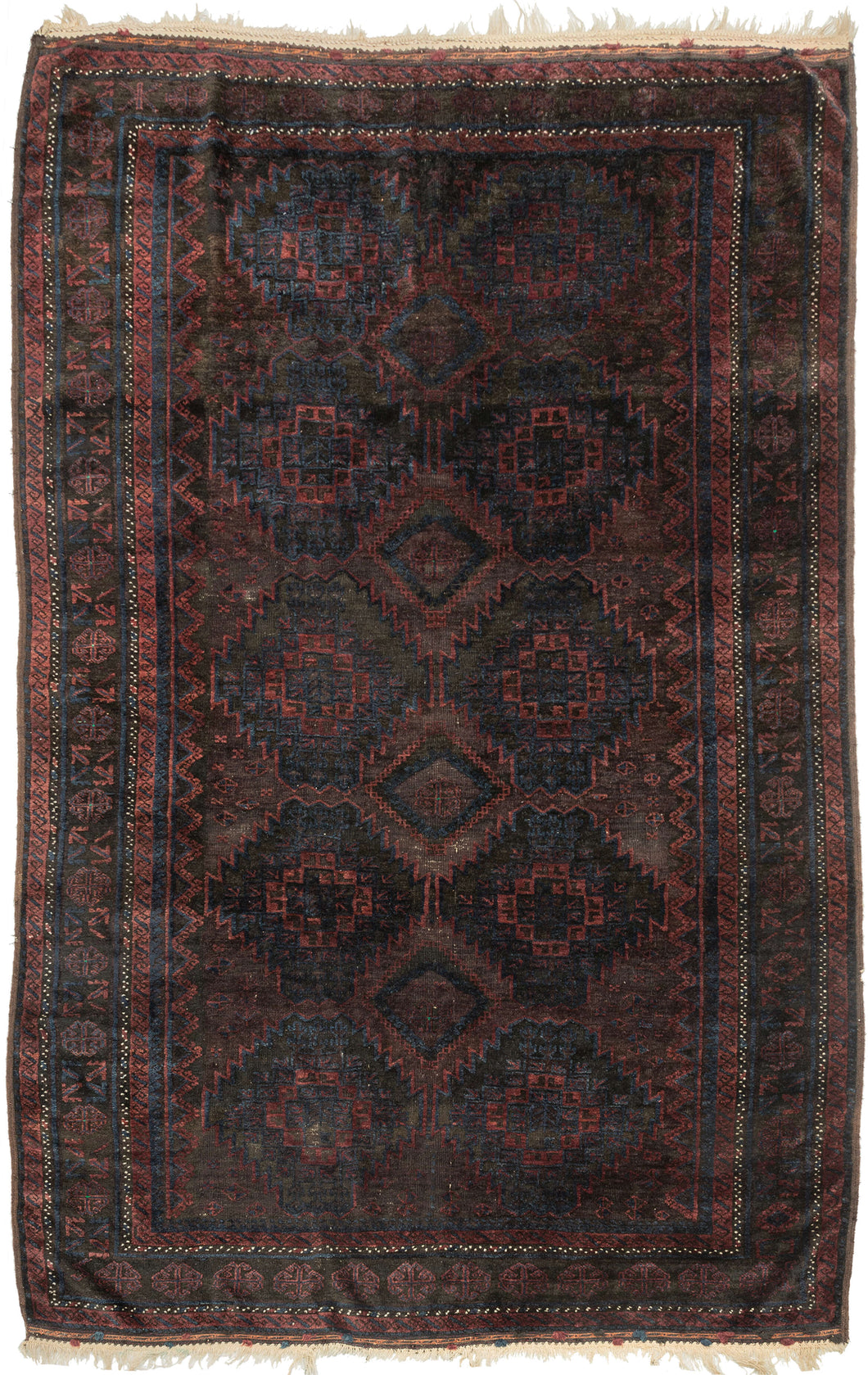 Timuri Baluch was handwoven during the second quarter of the 20th century in Western Afghanistan.
It features a lattice pattern of stepped diamonds and serrated polygons. With lush deep blue and red wool with a dark but lustrous complexion. The addition of a dark brown which has oxidized naturally sculpts the pattern and gives the shapes the feeling of floating in space. Bright speckles of white cotton have been woven around the main border adding a subtle touch of electricity. weft float