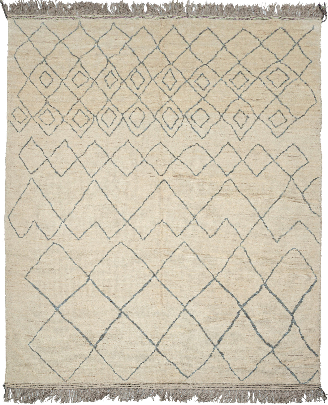 This Moroccan-styled rug was woven during the 21st century in Afghanistan.  It features an idiosyncratic pattern of diamond lattices. that have the feel of pencil quickly scribbled on paper. A simple palette of soft bluish gray lines which almost appear scribbled upon the shaggy cream ground. Woven of hearty, hand-spun Afghan wool giving it durability and extra heft not commonly found in the Moroccan weaving usually associated with this patterning.