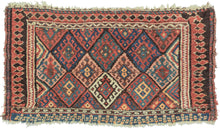 This bag face was woven by the Jaff Kurds of the Northern and Central Zagros mountains in Wester Iran during the late 19th century.  It features the classic Jaff interlocking diamond pattern in bright, cheerful colors. It is framed on three sides by a fun and wonky laleh abbasi border in black and red that becomes black triangles on a red ground before shifting back to laleh abbasi but with the colors reversed. The fourth side features red and white circles on an indigo ground.