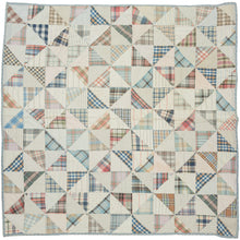 This vintage patchwork quilt was crafted in North America during the middle of the 20th century.
It features patch-worked grid composed of squares. Each square is formed of well balanced triangles of either colorful flannel patterns or more open dotted and striped cream ground patterning. The squares have been pieced together wondefully and the composition can be read many different ways that is accentuated by its perfectly square dimensions.