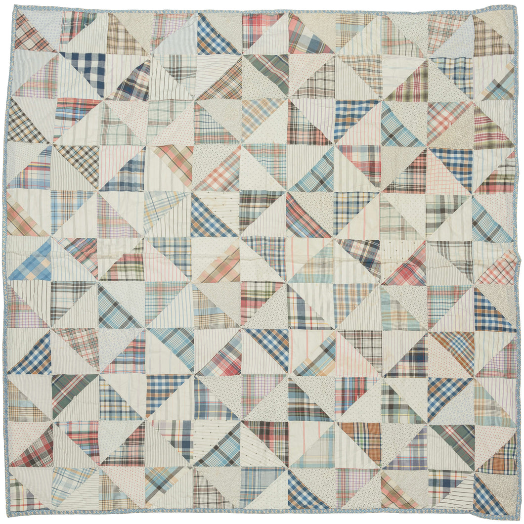 This vintage patchwork quilt was crafted in North America during the middle of the 20th century.
It features patch-worked grid composed of squares. Each square is formed of well balanced triangles of either colorful flannel patterns or more open dotted and striped cream ground patterning. The squares have been pieced together wondefully and the composition can be read many different ways that is accentuated by its perfectly square dimensions.