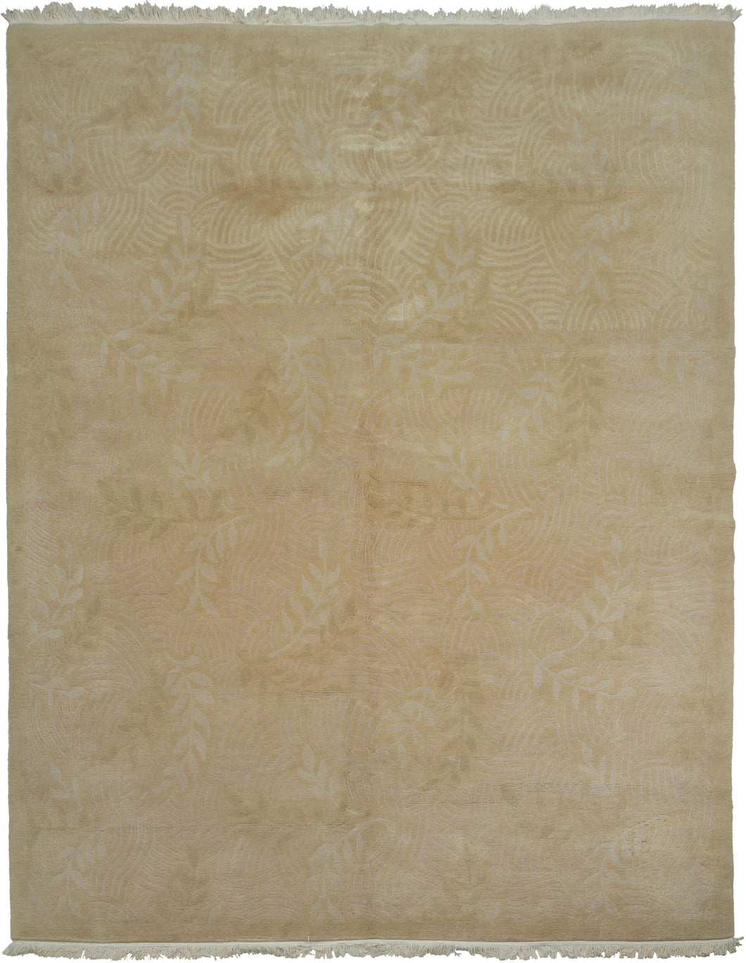 This Tibetan rug was woven during the late 20th century by Tibetan weavers in the Kathmandu Valley of Nepal for the Tufenkian Studio.
It is rendered in a tranquil tone-on-tone palette of warm golds, beiges, and soft dusty pink. The the rug features a subtle relief pattern of leafy vines and gentle wave motifs that are achieved through masterful carving and pile manipulation.The composition strikes a quiet harmony between texture and tone, allowing natural light to animate the surface with understated elega