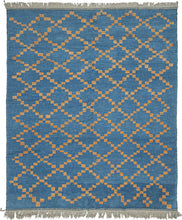 This Moroccan-styled rug was woven during the 21st century in Afghanistan.  It features a simple diamond lattice pattern comprised of speckled gold squares on a cobalt ground. The lattice is consistent but with some subtle nuance in it's rhythm and casually breaks apart near the top and bottom of the rendering. Woven of hearty, hand-spun Afghan wool giving it durability and extra heft not commonly found in the Moroccan weaving usually associated with this patterning.