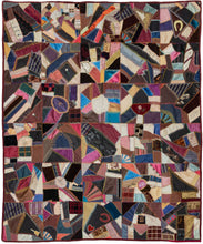 Crazy quilts are so-called "crazy" because they don't follow a specific pattern or quilt-block Victorian design sense. It features many symbols, a variety of fabrics and tiny detailed embroidered "borders" around each swatch of fabric. The symbols include horseshoes, hearts, flowers and even the text "Happy Easter". It was almost certainly intended as a family heirloom   Embroidered in one patch is the quilter's name and the date of the quilt - "Made by Debbie A. Smith 1896"