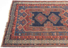 It features classic patterning associated with the Afshar people of Sirjan. In the center are two latch-hooked medallions on deep navy surrounded by a lacquer-red ground surrounded by a final field of cobalt.  Various greens, turqoise, apricot and aubergine contrast wonderfully and accentuate the various Small symbols and figures that fill the negative space. Nicely framed by an ivory main border which brightens the composition.