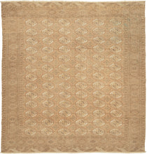 This Tekke Turkmen rug was handwoven during the second quarter of the 20th century in Turkmenistan.
The field features a grid of rounded main guls in various shades of brown, tan, bone and wheat on faded copper tone ground. The space between the grid is filled with rows of cruciform shaped secondary guls. It is encapsulated by a border of rams head filled octagons and finished with skirts of latch-hooked zigzags.