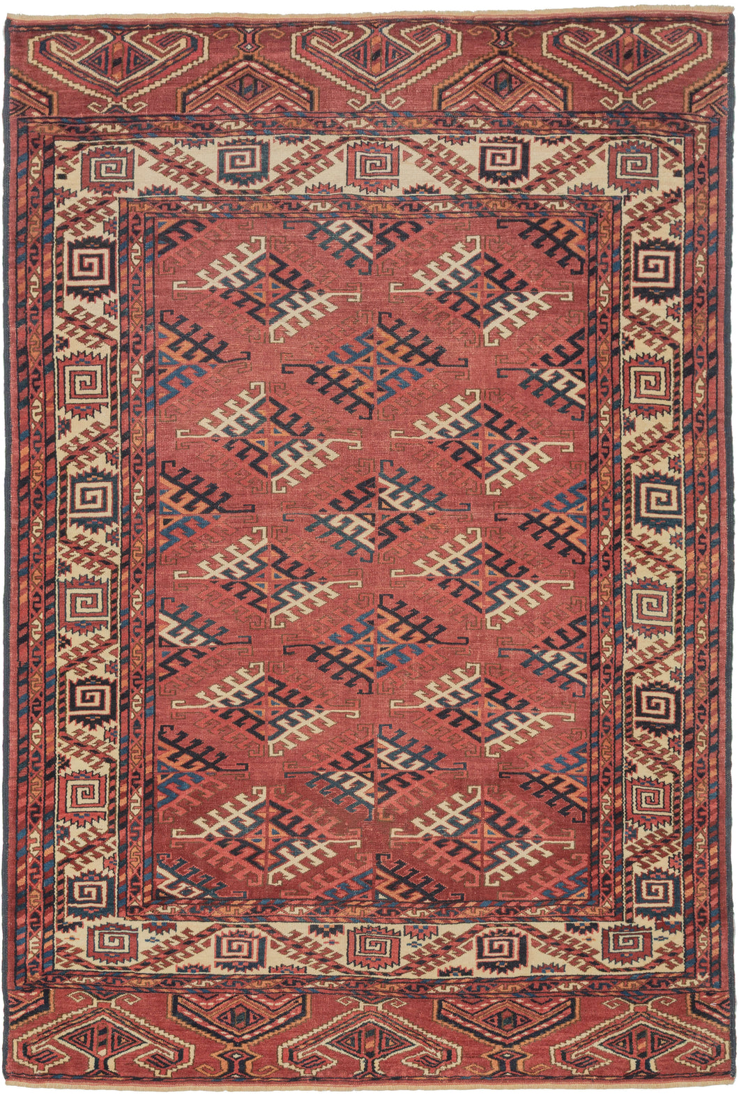 This Yomud Turkmen rug was handwoven during the early 20th century in Western Turkmenistan.
This finely balanced Yomud carpet features a repeating dyrnak-gul field in shades of plum, indigo, ivory, coral, apricot and sky blue. Each diamond-shaped motif radiates a strong tribal geometry, emblematic of Yomud weavings from the Caspian steppe.
