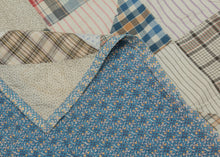 This vintage patchwork quilt was crafted in North America during the middle of the 20th century.
It features patch-worked grid composed of squares. Each square is formed of well balanced triangles of either colorful flannel patterns or more open dotted and striped cream ground patterning. The squares have been pieced together wondefully and the composition can be read many different ways that is accentuated by its perfectly square dimensions.