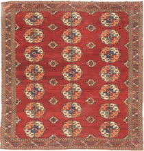 This Tekke main rug was handwoven during the first quarter of the 20th century in Turkmenistan.
The field features a grid rounded main guls in apricot, indigo, turquoise and ivory on vibrant red ground. The space between the grid is filled with rows of cruciform shaped secondary guls. In a rare square format that allows for very luxurious and open spacing of the guls.