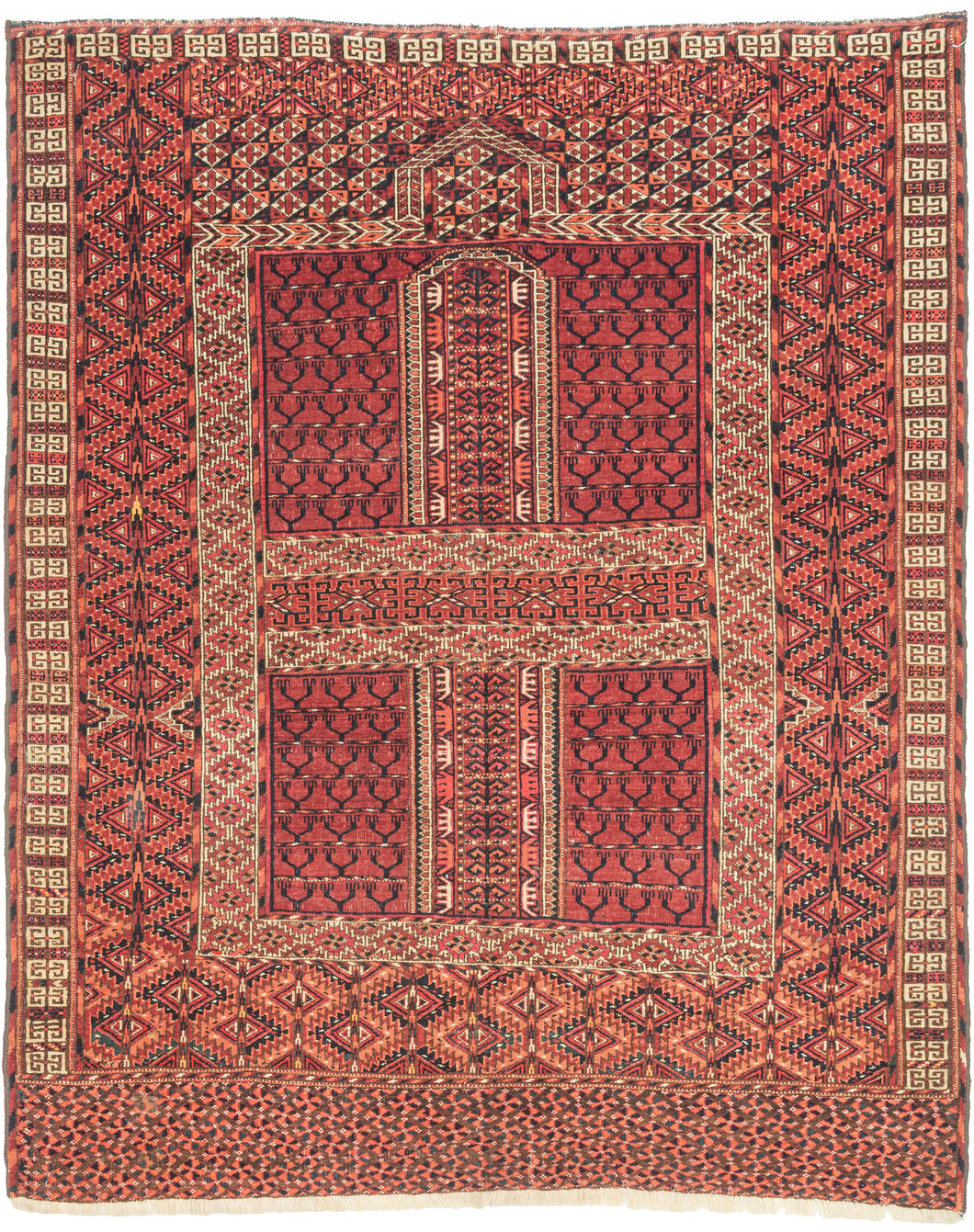 This finely woven Tekke ensi, or door rug, was woven in Southern Turkmenistan during the early 20th century. Its composition follows the traditional four-panel layout divided by a vertical and horizontal axis in a classic Hatchli format. Within each quadrant, stylized tree motifs rise in rhythmic symmetry as abstracted forms that may signify fertility, life, and renewal within the enclosed domestic world.