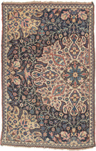 This rare and expressive Kurdish wagireh—or sampler rug—is a visual archive of design. Woven not for the market but as a reference tool, wagireh offered master weavers a compact way to preserve and transmit important elements of a pattern. Lush florals, scrolling vinery, and medallion fragments bloom in bold juxtaposition, floating across an asymmetrical field divided by tone and structure. The field’s deep indigo ground plays host to densely branched flowerheads and palmettes, while a large-scale ivory car