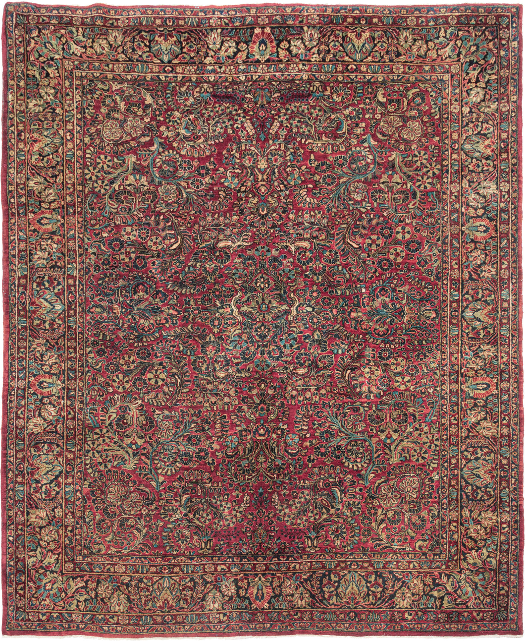 This rug features a curvilinear floral design on a red wine field. The floral work is intricate and an excellent example of the type of floral sprays Sarouk rugs are famed for. The main border features a palmette and blossom design on a navy ground. This classically patterned rug is perfect for high traffic areas and should last for generations to come.