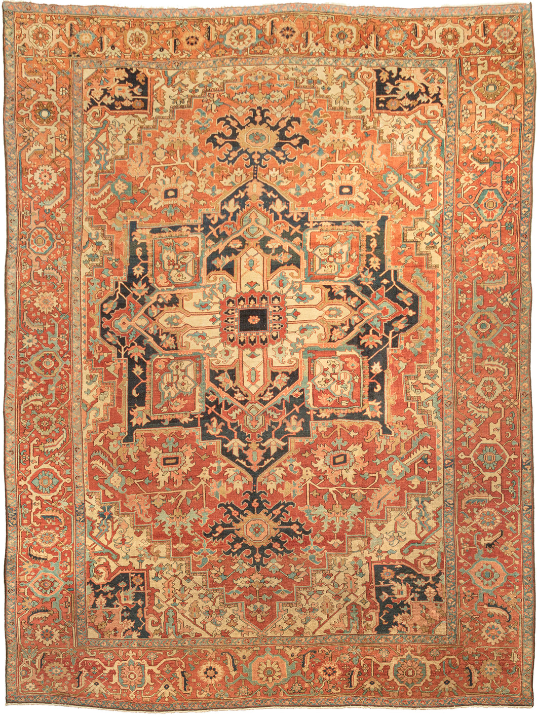 This Antique Serapi Rug features the classic Heriz layout with a graphic geometric central medallion. Great quality 19th-century Heriz rugs are often referred to as Serapi. Serapi patterning like what is exhibited here is often looser and freer than most later Heriz rugs. Serapis also have a softer palette and can include some unexpected tones.  A soft and balanced palette of soft brick, coral, powder blue, wheat, and coral contrasts well against ivory and deep navy.