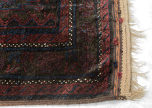 Timuri Baluch was handwoven during the second quarter of the 20th century in Western Afghanistan.
It features a lattice pattern of stepped diamonds and serrated polygons. With lush deep blue and red wool with a dark but lustrous complexion. The addition of a dark brown which has oxidized naturally sculpts the pattern and gives the shapes the feeling of floating in space. Bright speckles of white cotton have been woven around the main border adding a subtle touch of electricity. weft float