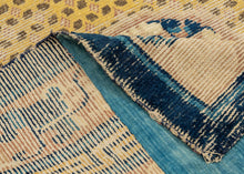 Ningxia Rug circa 1800 composed of a central mandala flanked by four smaller medallions over an intricate diamond lattice repeat. With a classic Ningxia palette that includes two shades of blue, brown, ivory, mauve and a desirable imperial yellow ground. The main border design features floral motifs on a mauve ground. The inner minor borders features a Greek key motif and the outer perimeter border features bands of both blue tones.