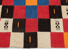 This blanket was likely woven by the Fulani people in Mali during the middle of the 20th century.
It was woven in multiple stripes which have been attached horizontally. It features an eye dazzling checkerboard composed of white, black, red, green, blue and a sunny yellow-orange. Four individual squares around the perimeter are woven with the red-yellow-green tricolor of the Malian flag.
Via The Metropolitan Museum of Art The checkerboard, a basic West African composition, ultimately may derive from