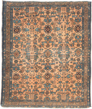 This Lilihan rug was handwoven by Armenians during the second quarter of the 20th century. 
It utilizes graphic floral patterning with an Art Deco feel. Rendered in lively blues, greens, and red with brown and gold on a coral ground. A central focal point blends seamlessly into the repeat field pattern. Framed by a meandering border on a red clay ground. 