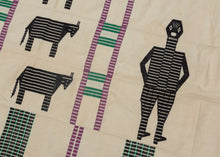 This blanket was likely woven in Nigeria during the middle of the 20th century.
It was woven in multiple stripes which have been attached horizontally. It features four human figures and six goats as well as various stripes in green, purple and black against an ivory ground. A wonderful and less common palette most often seen on Nigerian weavings. The figuresd and stripes have been completed using weft substition over the ivory strips.