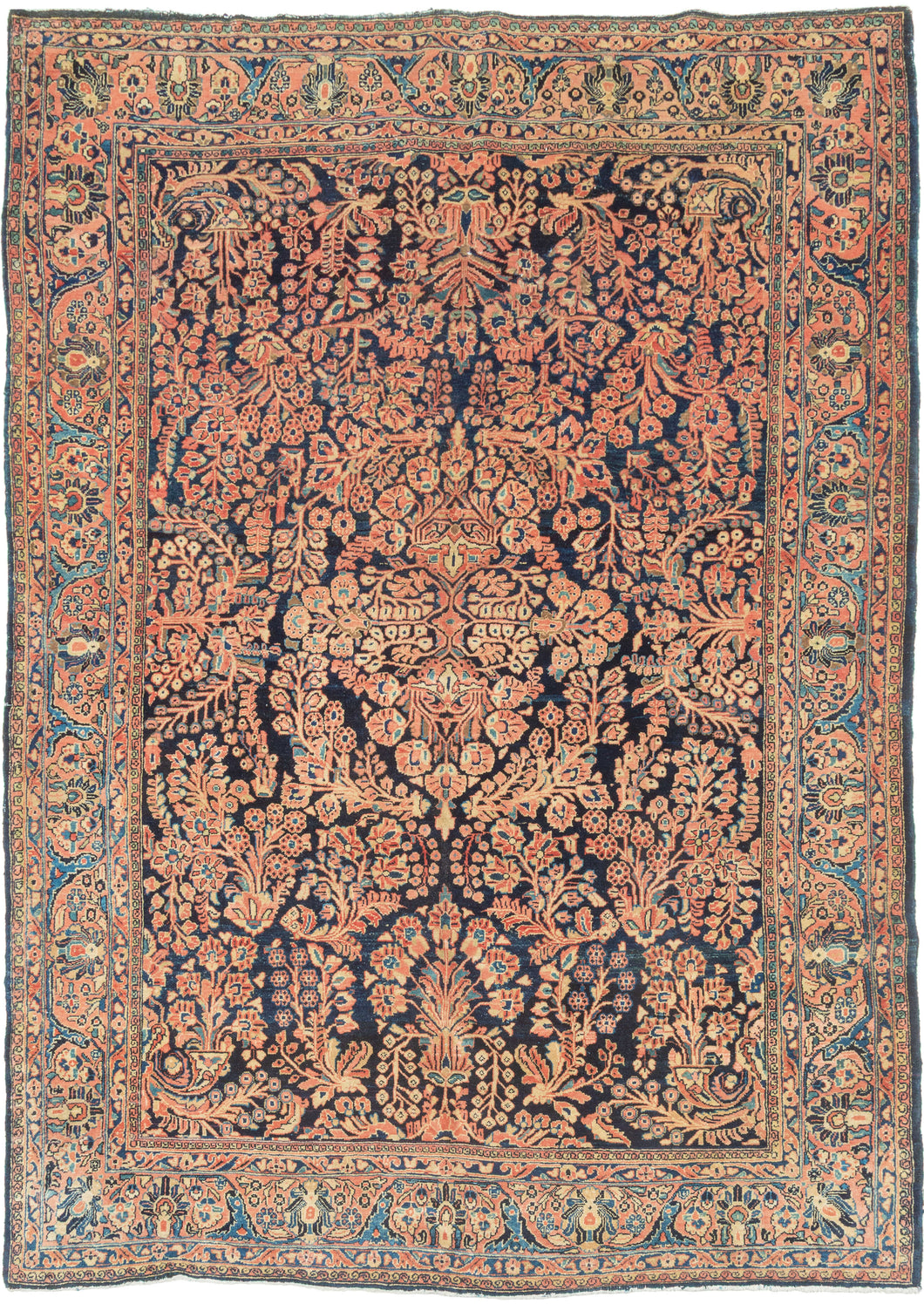 This rug features a curvilinear floral design on a deep navy field. The floral work is intricate and an excellent example of the type of floral sprays Sarouk rugs are known for. The main border features scrolling palmettes on a rust ground. In a desirable and less common ~6 x 9 size.
