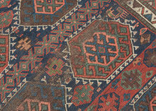 SANJABI KURD features a field of graphic hexagons filled with stylized protection symbols in rich tones of blues, reds, greens, coral, aubergine, gold, brown and ivory on a lively indigo ground. Each pair of hexagons is separated by bands of geometric shapes added in perfectly imperfect asymmetric fashion giving the composition a dynamic visual rhythm while the vibrant borders add welcomed balance and refinement. If you look closely you will find the inclusion of two camel like figures