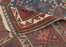 SANJABI KURD features a field of graphic hexagons filled with stylized protection symbols in rich tones of blues, reds, greens, coral, aubergine, gold, brown and ivory on a lively indigo ground. Each pair of hexagons is separated by bands of geometric shapes added in perfectly imperfect asymmetric fashion giving the composition a dynamic visual rhythm while the vibrant borders add welcomed balance and refinement. If you look closely you will find the inclusion of two camel like figures