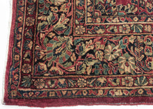 This rug features a curvilinear floral design on a red wine field. The floral work is intricate and an excellent example of the type of floral sprays Sarouk rugs are famed for. The main border features a palmette and blossom design on a navy ground. This classically patterned rug is perfect for high traffic areas and should last for generations to come. 